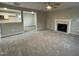 Living room with fireplace and view into kitchen at 223 Bonsai Way, Four Oaks, NC 27524