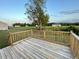 Wooden deck overlooks a spacious backyard with a scenic view at 223 Bonsai Way, Four Oaks, NC 27524
