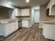 Modern kitchen featuring white cabinets, granite counters, and stainless steel appliances at 223 Bonsai Way, Four Oaks, NC 27524
