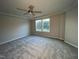 Spacious bedroom with ceiling fan and large windows at 223 Bonsai Way, Four Oaks, NC 27524