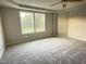 Spacious bedroom with plush carpeting and large windows offering natural light at 223 Bonsai Way, Four Oaks, NC 27524