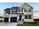 Two story home with a two car garage and landscaped yard at 223 Bonsai Way, Four Oaks, NC 27524