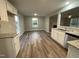 Open concept kitchen and dining area with luxury vinyl plank flooring at 223 Bonsai Way, Four Oaks, NC 27524