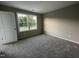 Spacious bedroom with neutral carpeting and large window at 223 Bonsai Way, Four Oaks, NC 27524