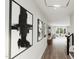 Bright hallway with wood floors and modern artwork at 4046 Elk Creek Ln # 62, Raleigh, NC 27612