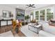 Bright living room featuring a fireplace, large windows, and comfortable seating at 4047 Elk Creek Ln # 13, Raleigh, NC 27612