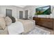 Bright bedroom featuring a large bed, dresser, and a view into the bathroom at 4047 Elk Creek Ln # 13, Raleigh, NC 27612