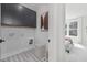 Laundry room with dark cabinets, patterned tile floor, and a view into a bedroom at 4047 Elk Creek Ln # 13, Raleigh, NC 27612