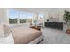 Bedroom with a king-size bed, sitting area, and large windows with a wooded view at 4047 Elk Creek Ln # 13, Raleigh, NC 27612