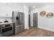 Modern kitchen features stainless steel appliances and gray cabinetry at 4047 Elk Creek Ln # 13, Raleigh, NC 27612