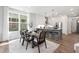Dining area with a glass top table and black chairs, located near the kitchen at 4047 Elk Creek Ln # 13, Raleigh, NC 27612