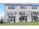 Rear view of townhome showcasing private balconies and backyard at 4047 Elk Creek Ln # 13, Raleigh, NC 27612