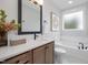 Bathroom with freestanding tub, vanity with quartz countertop, and marble tile floor at 4047 Elk Creek Ln # 13, Raleigh, NC 27612