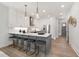 Modern kitchen with white cabinets, gray island, and stainless steel appliances at 4047 Elk Creek Ln # 13, Raleigh, NC 27612