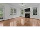 Gathering room with hardwood floors, fireplace and built-in entertainment center at 2 Piney Ridge Ct, Durham, NC 27712