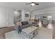 Open living room showcasing a sectional sofa, coffee table, and views into the kitchen and dining area at 104 Vallco Ln, Durham, NC 27713