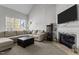 Living room with sectional sofa, fireplace, and large window at 5004 Royal Troon Dr, Raleigh, NC 27604