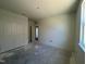 Unfinished bedroom with double doors and window at 77 Frasier Fir Way, Lillington, NC 27546