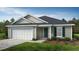 New construction home with gray siding, white garage door and teal shutters at 77 Frasier Fir Way, Lillington, NC 27546