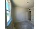 Unfinished bedroom with large window and door at 77 Frasier Fir Way, Lillington, NC 27546
