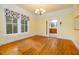 Bright dining room with hardwood floors, chandelier, and view into kitchen at 230 Chavasse Ave, Henderson, NC 27536