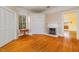 Spacious living room featuring hardwood floors, a fireplace, and built-in shelving at 230 Chavasse Ave, Henderson, NC 27536