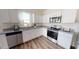 Modern kitchen with white cabinets and stainless steel appliances at 388 Glover Pk Mem Dr, Nashville, NC 27856