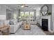 Living room featuring a neutral color palette, fireplace, and ample natural light at 5013 Trotter Dr, Raleigh, NC 27603