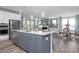 Open concept kitchen with island, gray cabinets, and stainless steel appliances at 5013 Trotter Dr, Raleigh, NC 27603