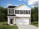 Two-story house with white and beige siding, black shutters, and a two-car garage at 400 Glover Park Mem Dr, Nashville, NC 27856