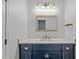 Modern bathroom with a navy vanity, marble countertop, and gold fixtures at 4811 Homeplace Dr, Apex, NC 27539