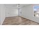 Bedroom with wood-look floors, ceiling fan and two large windows at 4811 Homeplace Dr, Apex, NC 27539