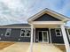 Rear view of house showing gray siding, covered patio, and sliding glass door at 566 John Stark Dr, Fuquay Varina, NC 27526