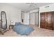 Bedroom with ceiling fan, hardwood floors, and large mirror at 1000 Lamond Ave, Durham, NC 27701