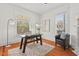 Bright home office features hardwood floors, stained glass window, and built-in shelving at 1000 Lamond Ave, Durham, NC 27701