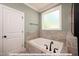 Relaxing bathroom with soaking tub and tile surround at 775 Vick Rd, Spring Hope, NC 27882