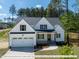Two story house with white siding, gray roof, and stone accents at 775 Vick Rd, Spring Hope, NC 27882