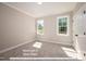 Main floor bedroom with neutral carpet and large windows at 775 Vick Rd, Spring Hope, NC 27882