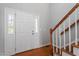 Bright entryway with hardwood floors and a view to the stairs and kitchen at 3431 Old Chapel Hill Rd, Durham, NC 27707