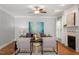 Cozy living room features hardwood floors, fireplace, and large windows at 8406 Wheatstone Ln, Raleigh, NC 27613