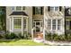 Brick steps leading to a glass front door, flanked by bay windows and landscaping at 117 Torrey Pines Dr, Clayton, NC 27527