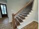 Modern staircase with wood and black metal railing at 230 Grading Stick Ct, Angier, NC 27501