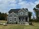 Two story home with gray siding, landscaping, and stone accents at 230 Grading Stick Ct, Angier, NC 27501