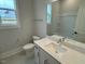 Clean bathroom with white vanity, quartz countertop and bathtub at 230 Grading Stick Ct, Angier, NC 27501