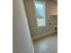 Bright laundry room featuring tile flooring and ample shelving at 230 Grading Stick Ct, Angier, NC 27501
