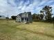 Two story home with gray siding, landscaping, and stone accents at 230 Grading Stick Ct, Angier, NC 27501