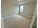 Bright bedroom with carpeted floors and a window at 230 Grading Stick Ct, Angier, NC 27501