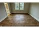Spacious bedroom with wood-look flooring and large windows at 230 Grading Stick Ct, Angier, NC 27501