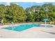 Community pool with lounge chairs and a fun splash pad at 279 N Maple Walk Dr # 216, Garner, NC 27529