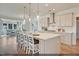 Modern kitchen with a large island and white cabinets at 279 N Maple Walk Dr # 216, Garner, NC 27529